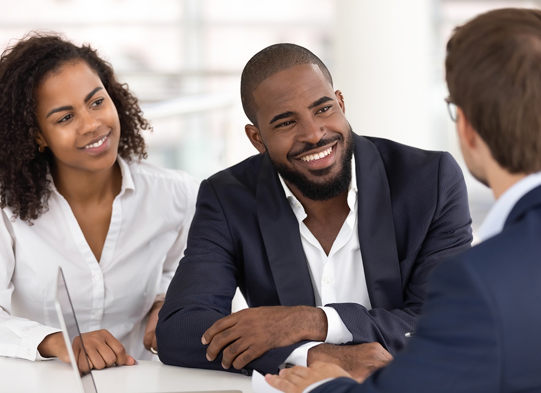 About Our Agency - Cheerful Business Couple Meet With an Agent at His Office