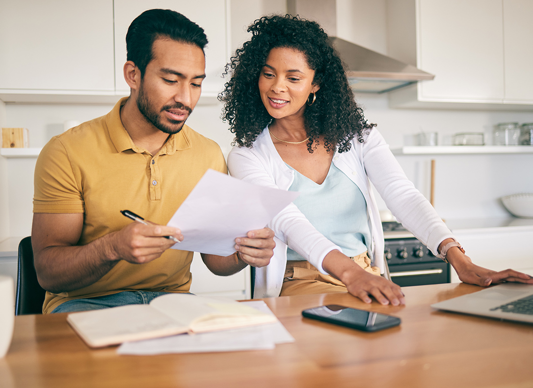 Why are my rates going up - Couple Reviewing Documents at Home
